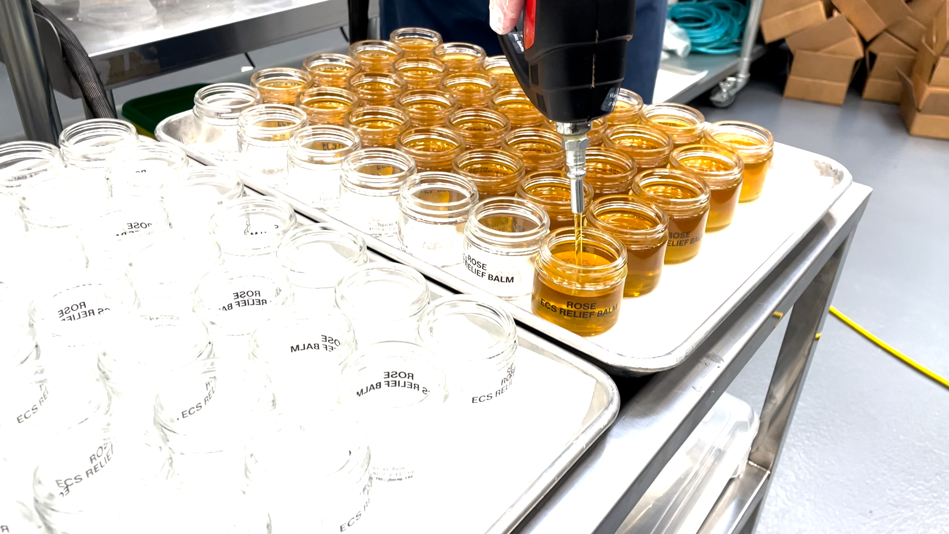 Herbal balm production line with labeled jars and lids